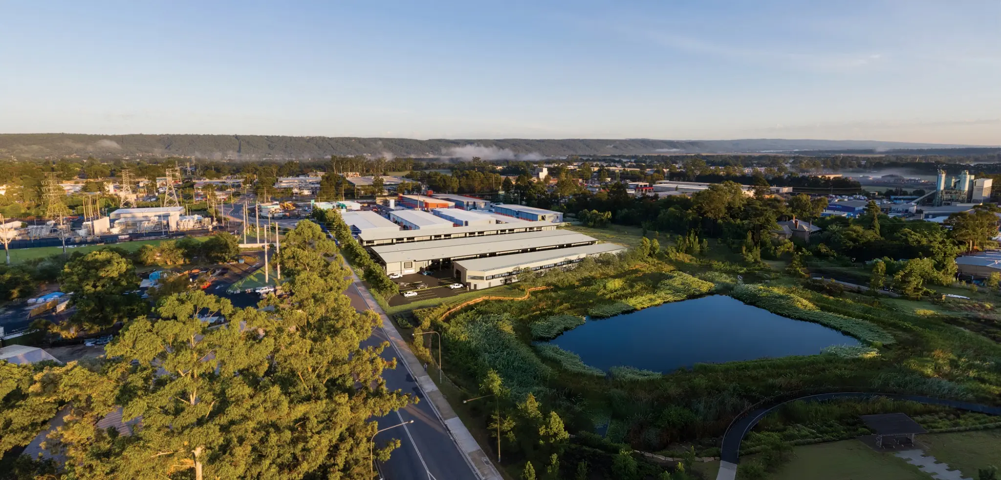 Aerial architectural photomontage of a large industrial development in Penrith integrated beside existing infrastructure, businesses, roads and wetlands